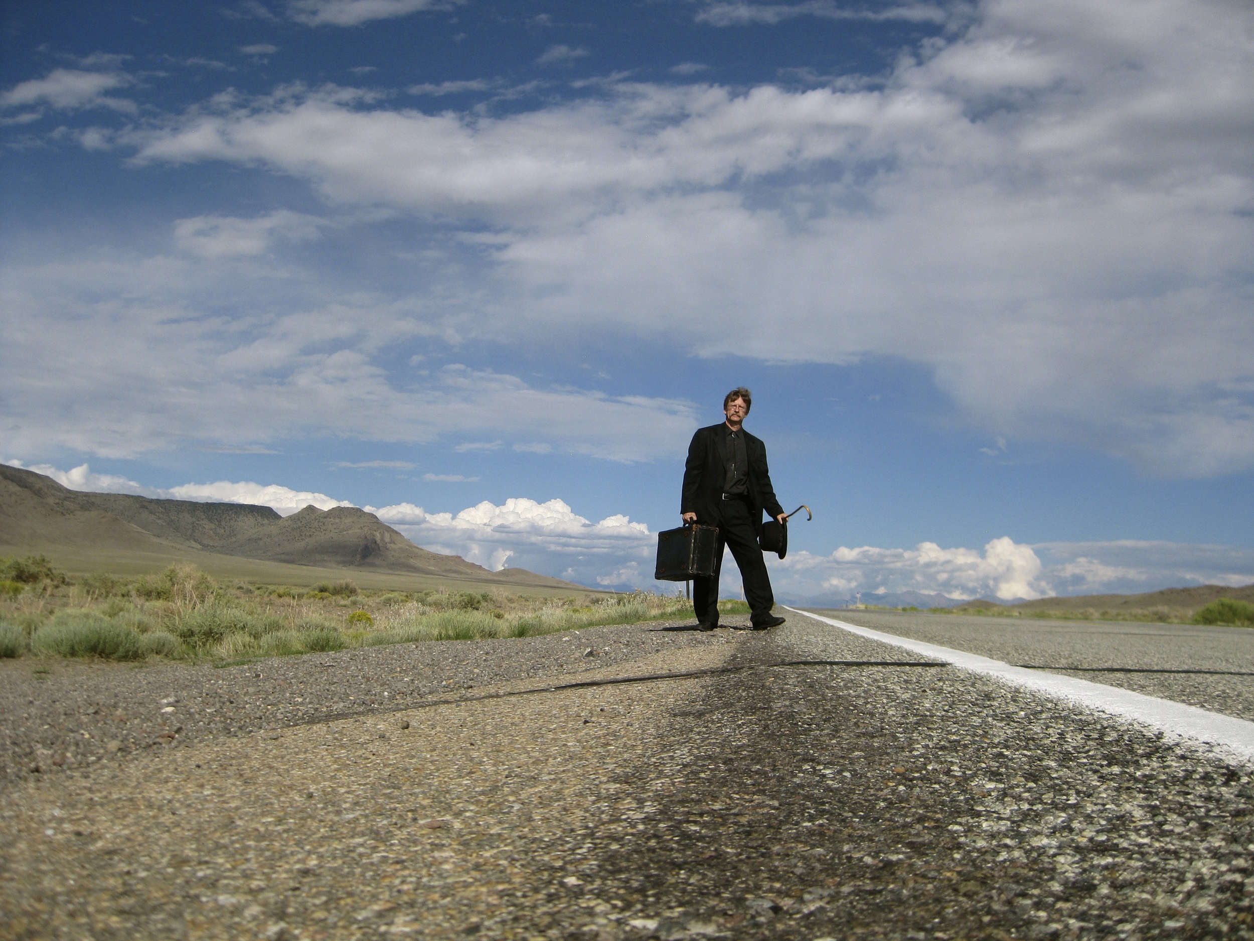Cody Landstrom with suitcase in landscape